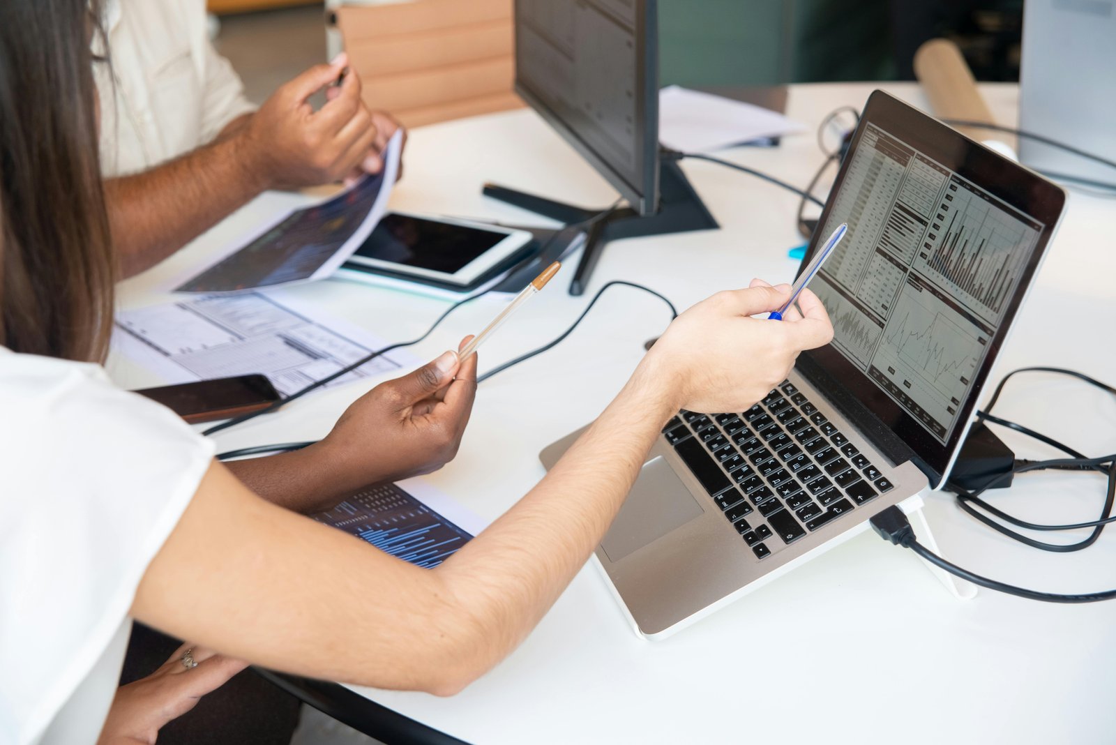 Professionals reviewing financial charts during origination research